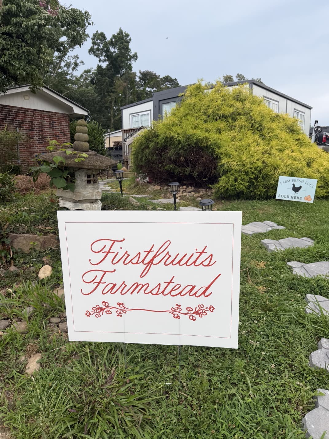 Firstfruits Farmstead sign in the garden out front of the farm shop